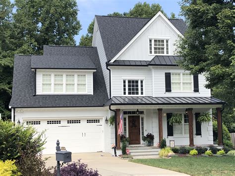 white houses with black metal roof|house with black metal roof.